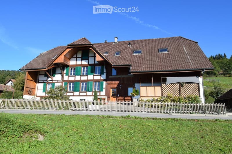 2 story house, brown roof, green shutters, wooden fence, garden