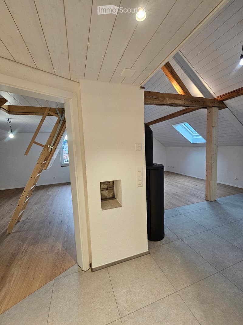 wooden beams, tiled floor, wooden ladder, white walls, power outlets, windows, smokestack