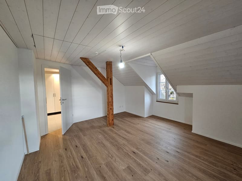 wooden floor, wooden beam, white walls, empty room, windows, open door, light fixture