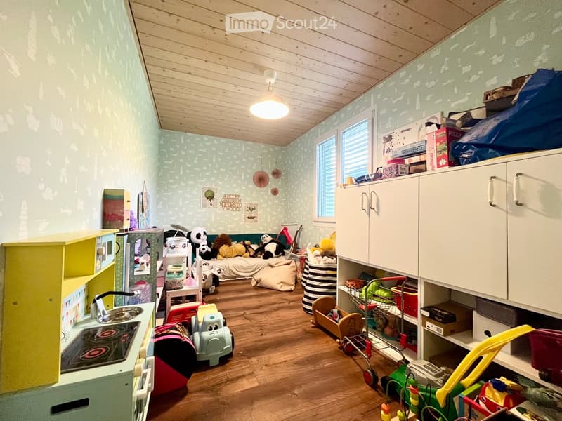 {"type": "Furnished Room", "objects": ["bed", "toy car", "toy trolley", "kitchenette", "cupboard", "toy shelf", "toy stove", "toy sink", "toy refrigerator", "toy microwave", "toy oven", "toy cabinet", "toy table", "toy chair", "toy sofa", "toy bed", "toy