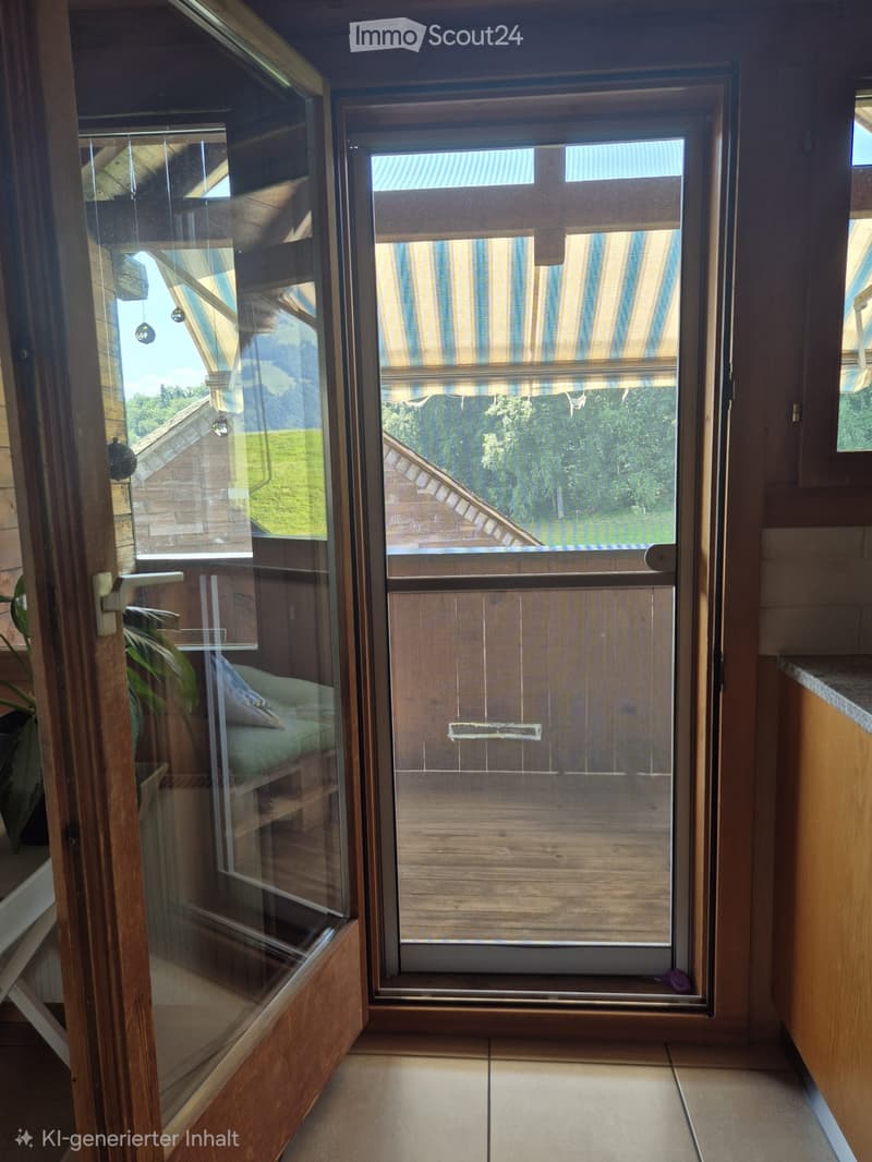 Balcony with wooden frame, glass door, striped blinds, and view of the roof and greenery.