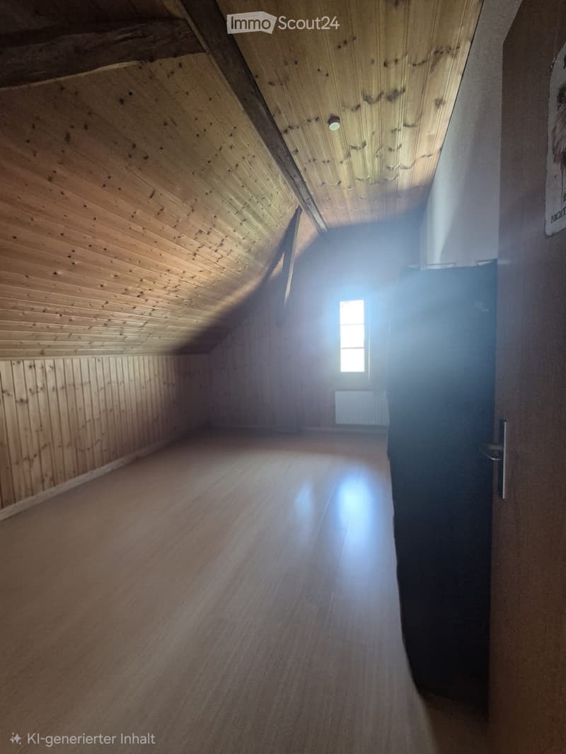 Empty attic space with wooden walls, ceiling, and floor, featuring a small window at the far end.
