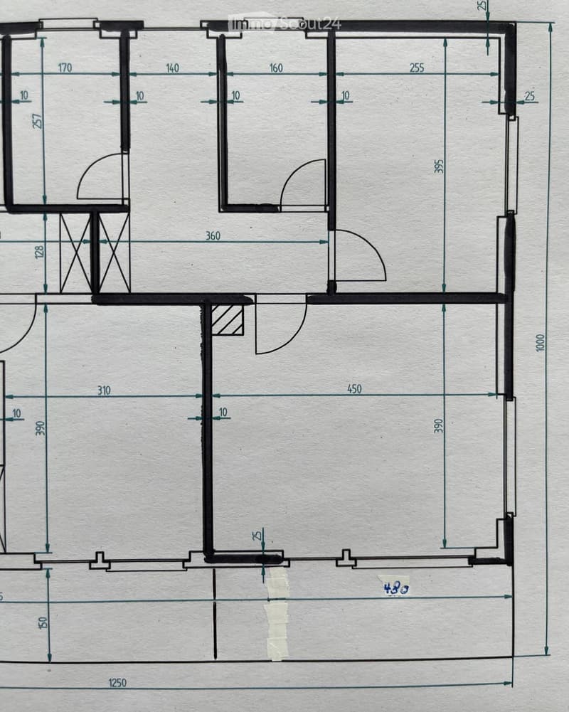 Floor plan of a residential space with labeled dimensions, including a large central room, smaller rooms, and a hallway.