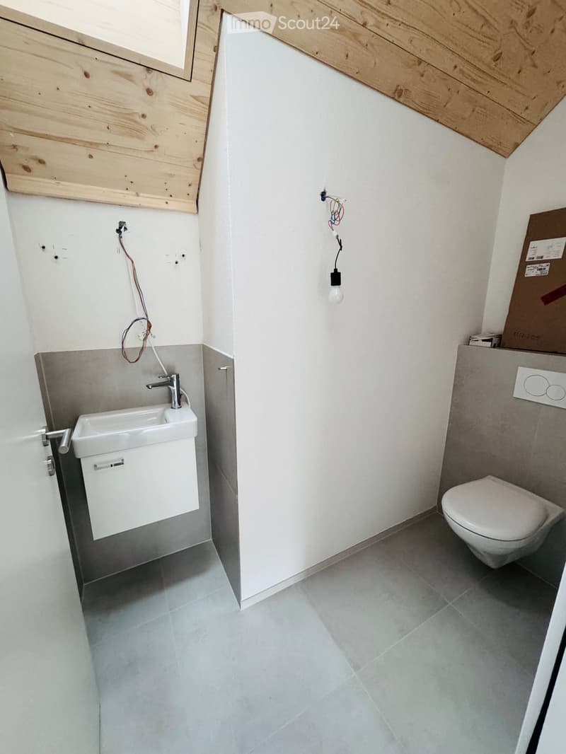 small bathroom with sink, toilet, tiled floor, wooden ceiling