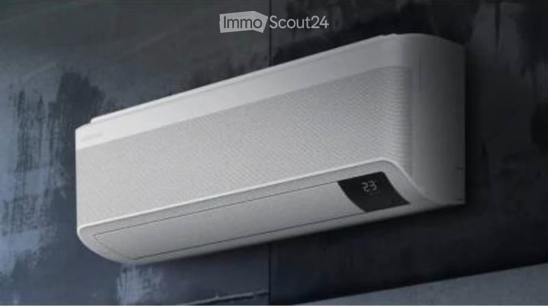 A modern white wall-mounted air conditioner unit with a digital display showing the temperature as 23°C.
