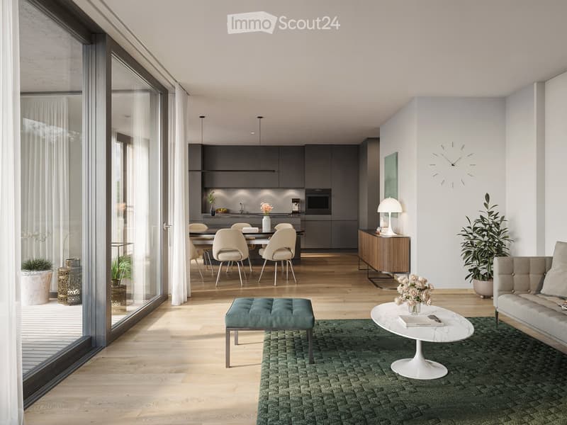 Modern living and dining area with light wood flooring, large windows, grey sofa, white coffee table, green rug, dining table with chairs, kitchen area with cabinets and appliances.
