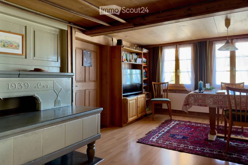wooden floor, fireplace, dining table, chairs, rug, TV, bookshelf, picture frame, windows