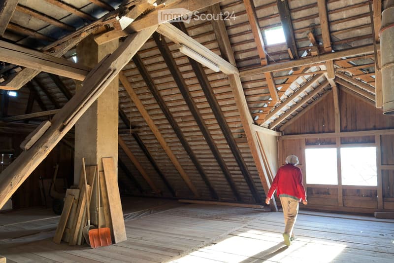 wooden beams, wooden floor, windows, shovels, person walking