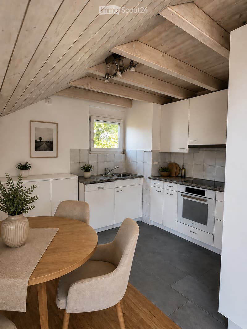 Modern kitchen with white cabinets, stainless steel appliances, a wooden dining table with chairs, and a window overlooking greenery.