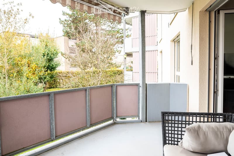 modern furnished balcony, metal railings, beige sofa, beige cushion