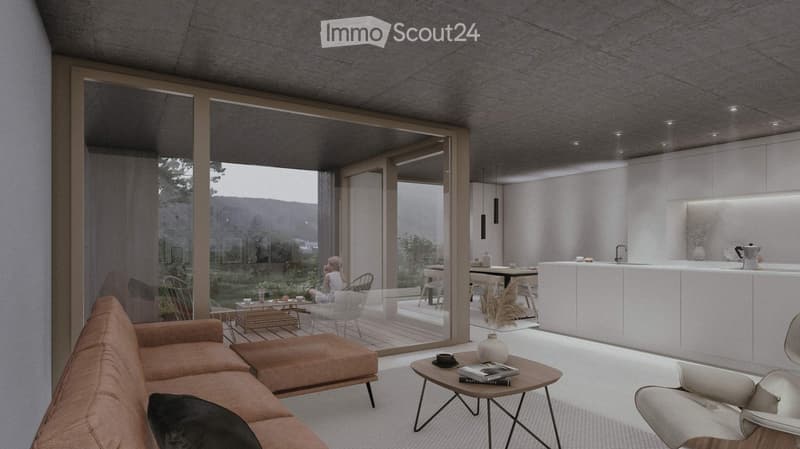 Spacious open-plan living area with large windows offering a scenic mountain view, modern white kitchen, comfortable sofa, and coffee table