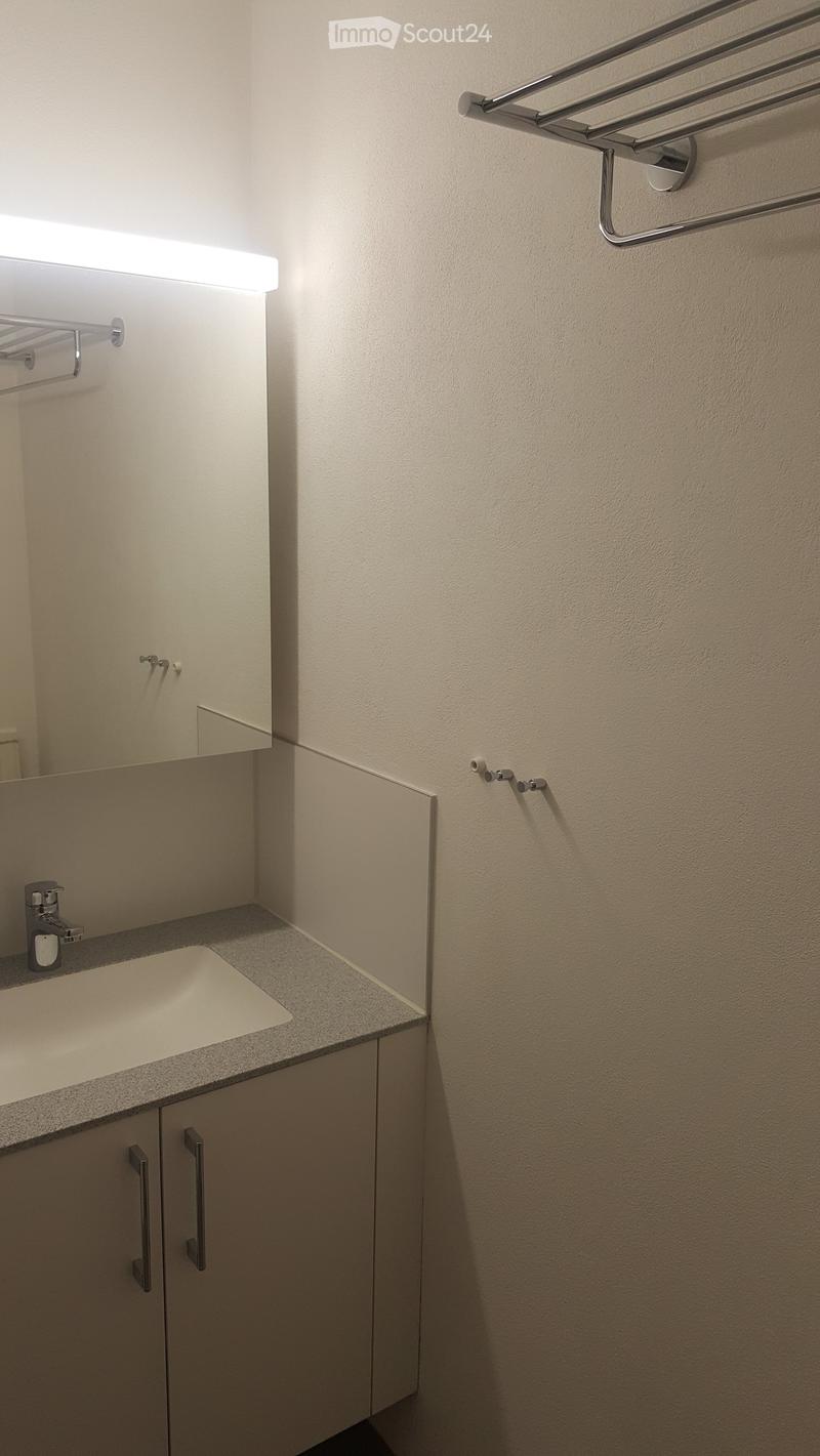 Bathroom with sink, cabinet, and a mirror.