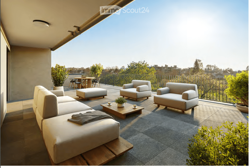 Modern rooftop terrace with comfortable seating, small table, and potted plants, offering a scenic city view.