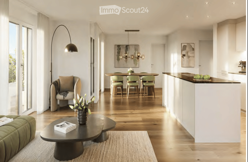 Modern open-plan living and dining area with a green sofa, coffee table, dining table with chairs, and a kitchen island.