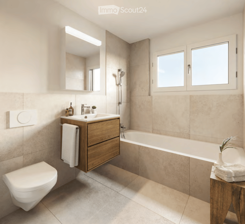 Modern bathroom with a wooden vanity, sink, toilet, bathtub, and large windows for natural light. Includes a mirror, towel, and small plant on a wooden shelf.