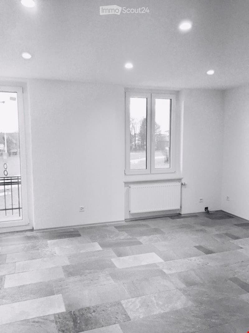 room with white walls and windows, a white tile floor, and a window with a view