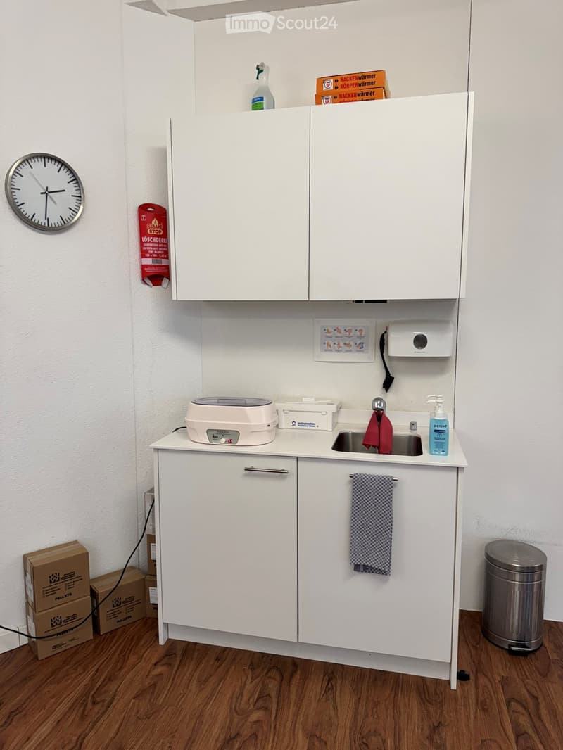 small kitchen area with sink, cabinets, countertop, and appliances