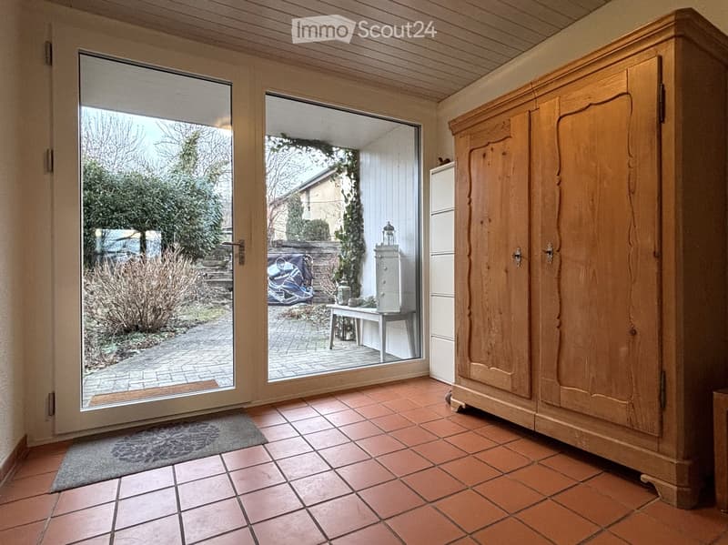 wooden floor, tiled floor, large glass doors, outdoor brick pathway, outdoor table and chairs