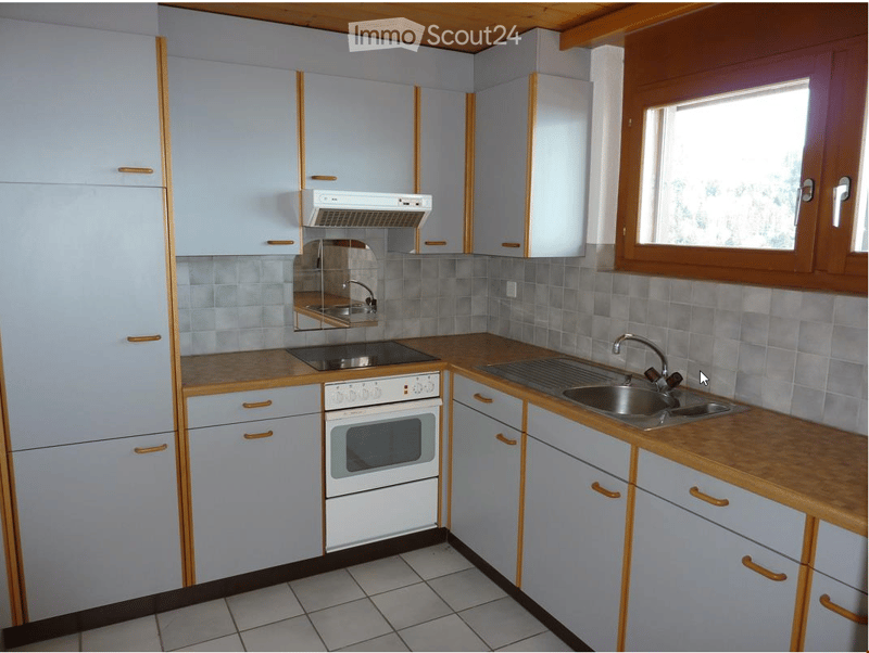 tiled floor, gas stove, oven, double sink, white cabinets, stainless steel faucet, extractor hood, wooden countertop