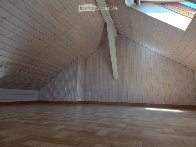 Empty room with wooden walls, wooden ceiling, and wooden floor. Skylight window at the top right corner.