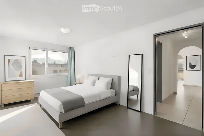 Modern bedroom with a large bed, nightstand, mirror, and picture frame on the wall. The room features large windows with a view and a sleek, contemporary design.