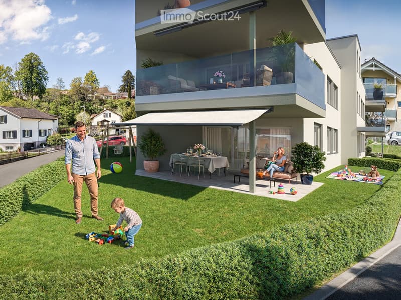 Family-friendly garden area with a modern house, green lawn, outdoor seating, and toys.