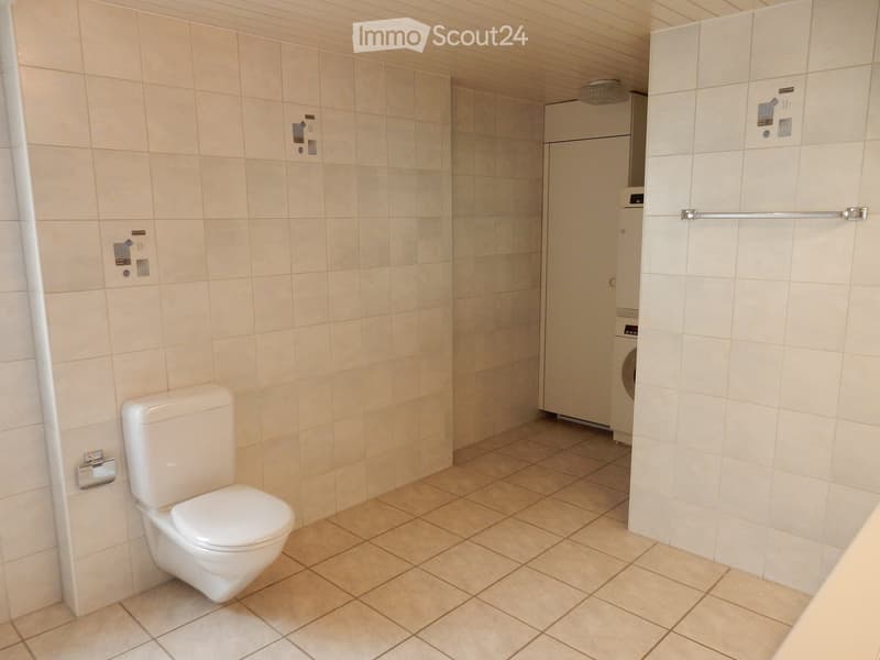 Single toilet, built-in sink, tiled floor, ceiling with recessed lighting, a door to a laundry room, and a towel rack on the wall