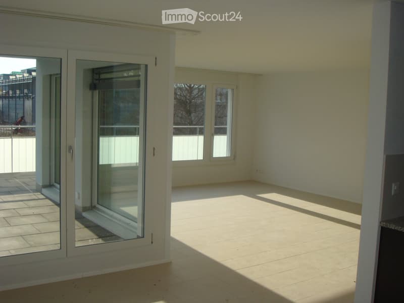 Empty room with tiled floor, large sliding glass doors, and windows allowing natural light. No furniture or equipment present.