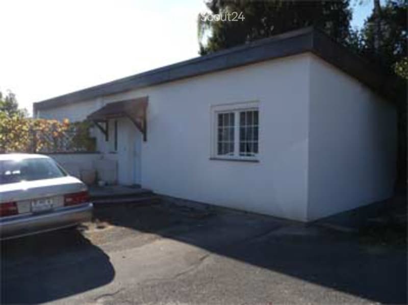 white exterior, single story, single window, car parked in front