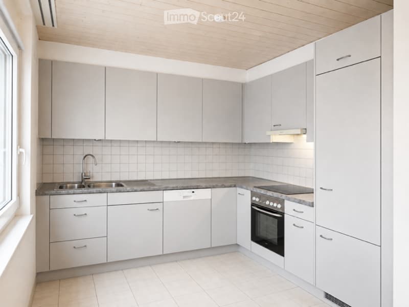 Modern kitchen with white cabinets, granite countertops, and stainless steel appliances including a sink, oven, and dishwasher.