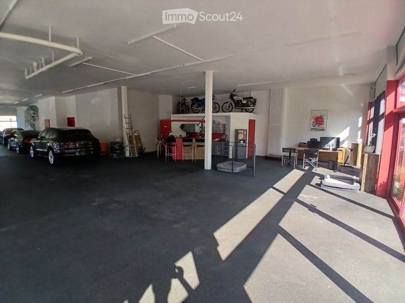 {"visible_features": ["Garage"], "type": "Garage", "objects": [], "description": "Spacious garage with multiple vehicles, including cars and motorcycles, and a small office area with desks and chairs.", "localized_descriptions": {"EN": "Spacious garage wi