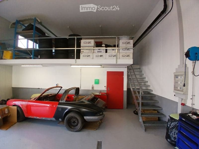 {"visible_features": ["Garage"], "type": "Garage", "objects": [], "description": "Garage with a red and black convertible car, metal staircase, storage boxes, and a red door.", "localized_descriptions": {"EN": "Garage with a red and black convertible car,