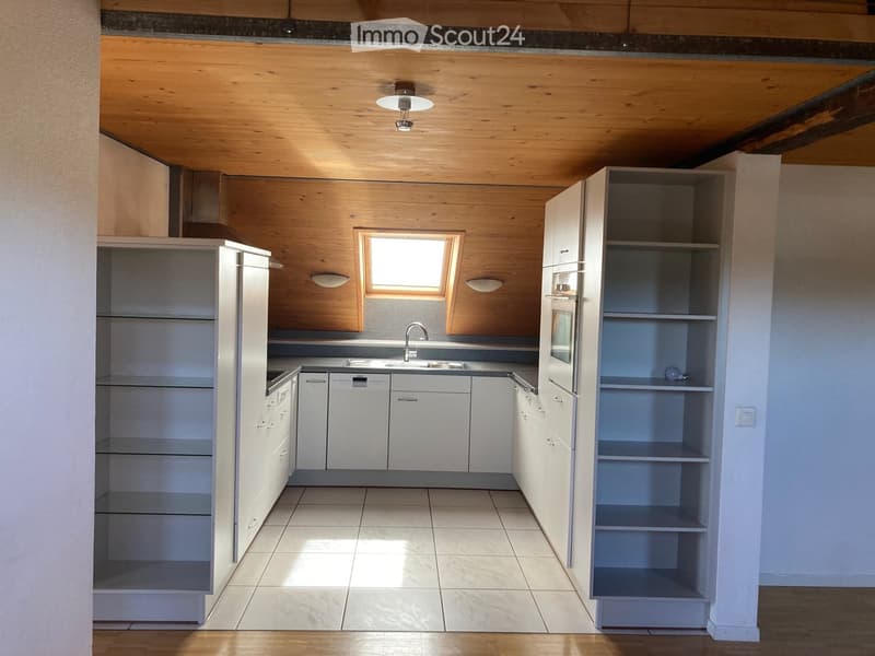 Modern kitchen with white cabinets, stainless steel appliances, and a central island. Features a sink, faucet, refrigerator, oven, and dishwasher.