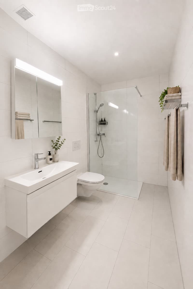Modern bathroom with white tiles, a large mirror, a sink with a chrome faucet, a toilet, a glass-enclosed shower, and neatly arranged towels and plants.