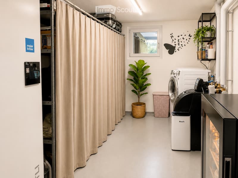 Modern bathroom with a washing machine, dryer, refrigerator, trash bin, potted plant, and curtained shower area.