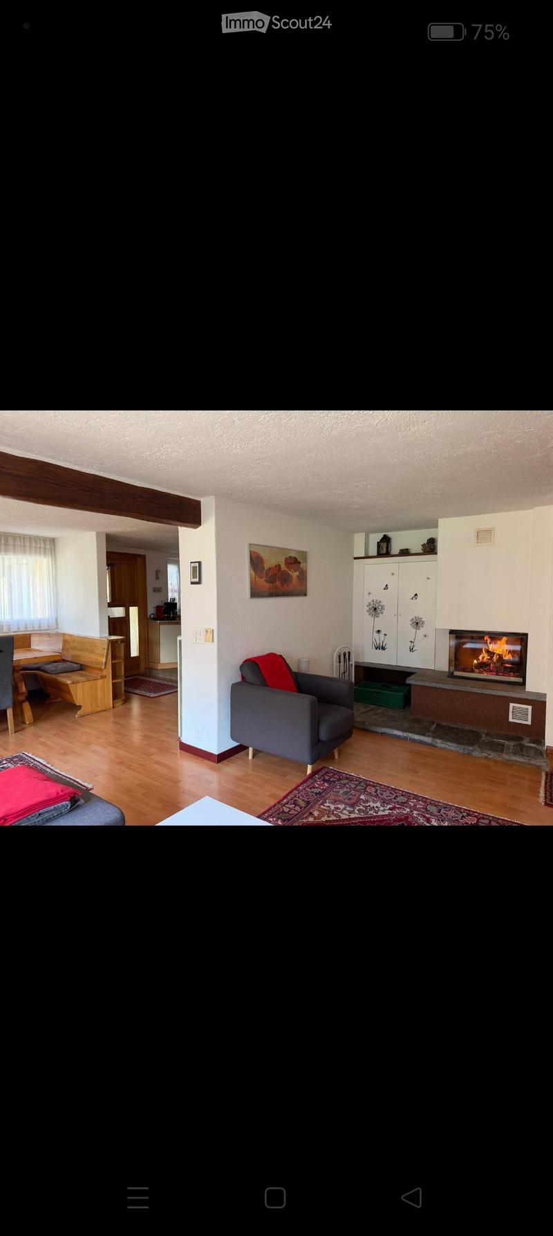 Living room with a fireplace, sofa, chair, coffee table, bench, and a painting on the wall.