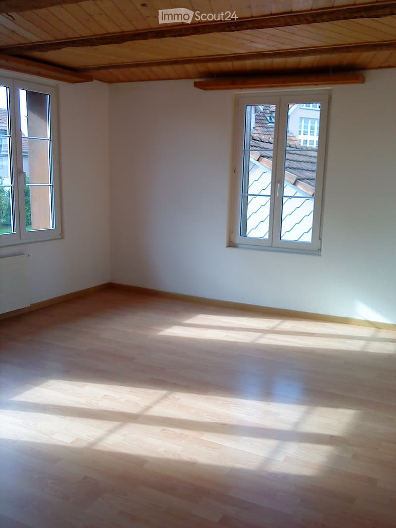 empty room, hardwood floor, white walls, two windows, wooden ceiling