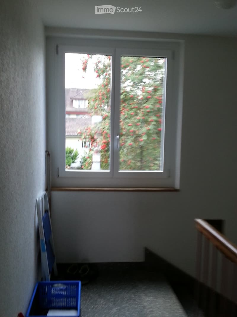 White walls, double window, stairs in the room