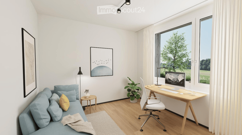A modern, well-lit room with a light blue sofa, a wooden desk with a computer, a white office chair, a small side table with a plant, and two picture frames on the wall.