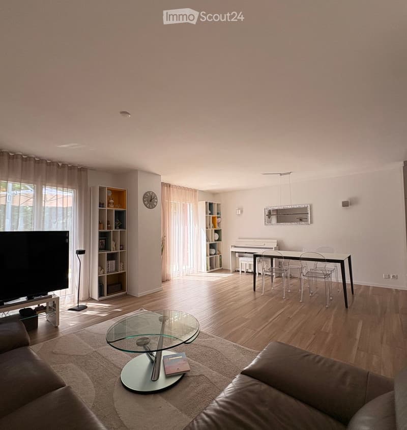 A modern living room with a sofa, coffee table, dining table, chairs, piano, shelves, and a large window with curtains.
