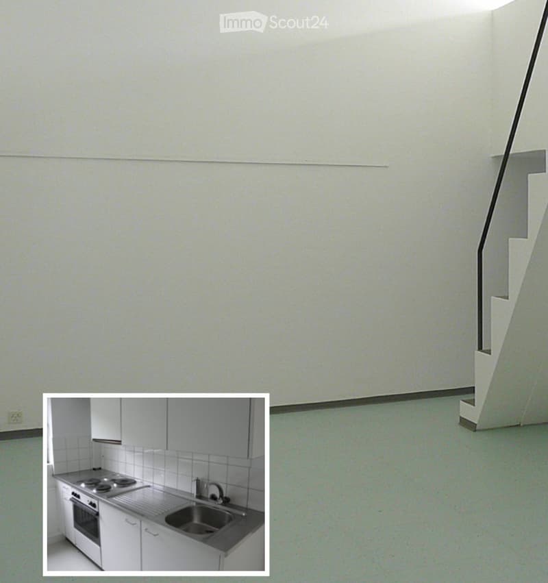 Empty room with light-colored walls and a green floor, featuring a staircase in the corner and an inset image of a modern kitchen.