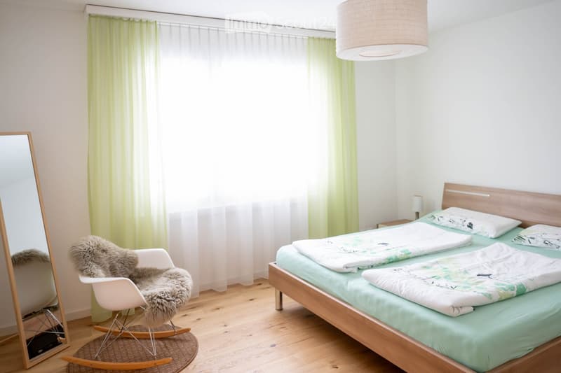 Single bed, bedspreads, bedside table, lamp, full-length mirror, chair, rug, curtain