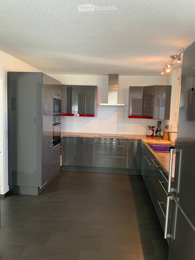 modern gray kitchen with wooden countertops, integrated appliances, stainless steel sink