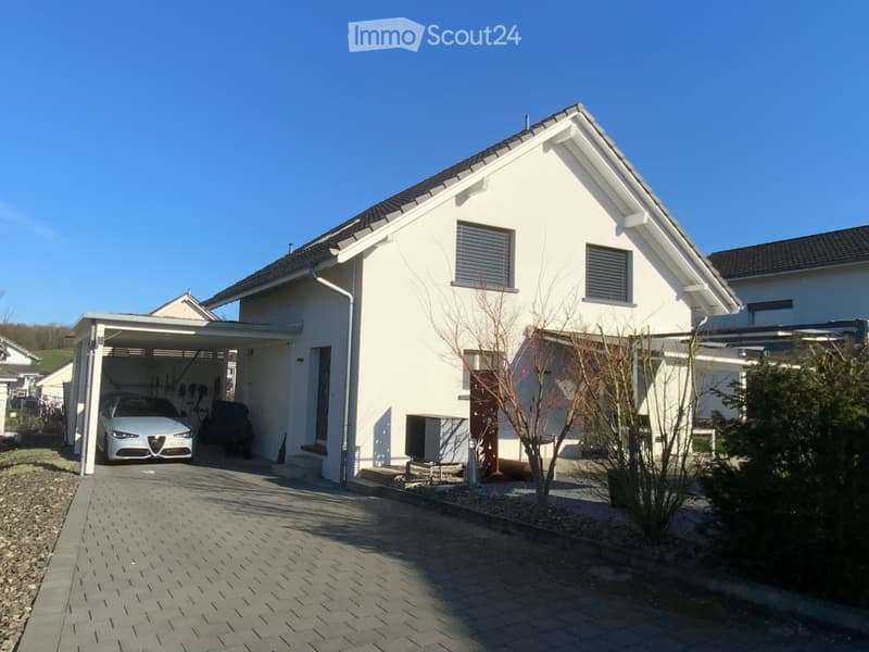 Modern white house, 2 stories, garage with car, paved driveway, garden