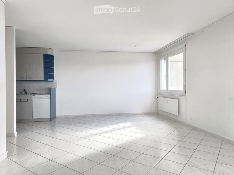 empty room, white tiles, white walls, kitchen area with cabinets, sink, dishwasher, window