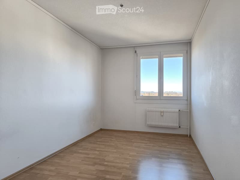 empty room, white walls, wooden floor, large window, white radiator