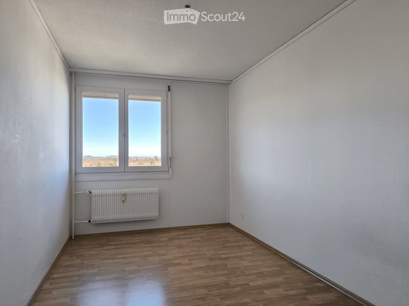 empty room, white walls, wooden floor, window, radiator