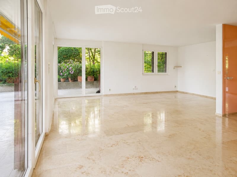 Empty room with large sliding glass doors leading to a patio, white walls, and a polished tile floor.