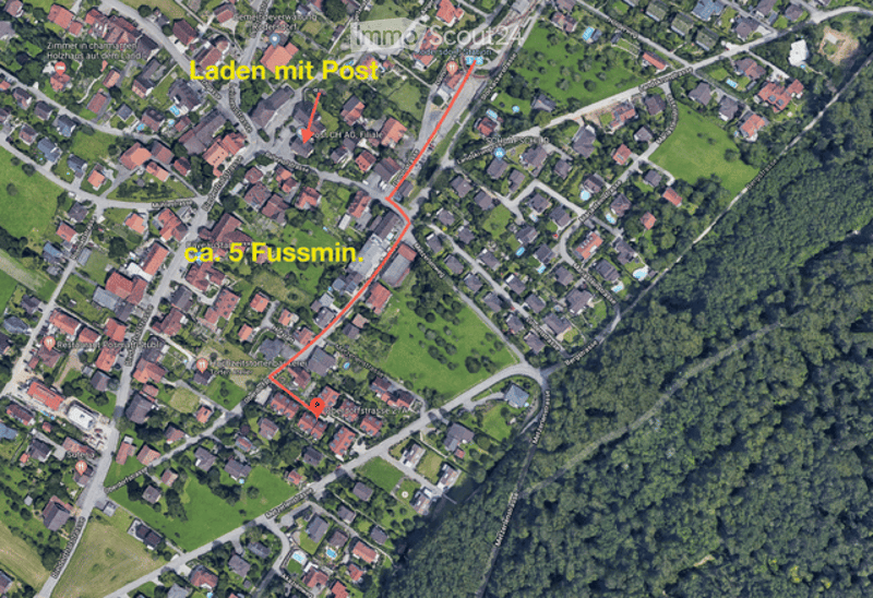 Aerial view of a residential area with multiple houses, streets, and green spaces. A highlighted path indicates a distance of approximately 5 feet.