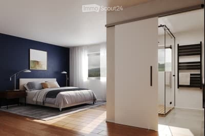 Modern bedroom with dark blue walls, a large bed with pillows and a blanket, nightstands with lamps, a picture frame on the wall, and an adjacent shower stall with a towel rack.